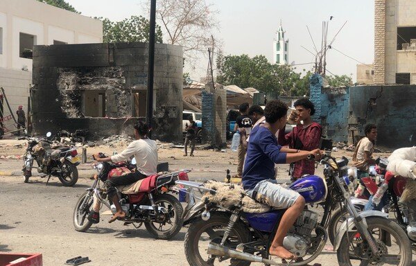 Yemenis inspect the site of an ISIS suicide car bombing that targeted a police station in Aden's al-Sheikh Othman district on August 1st. [Nabil Hasan/AFP]