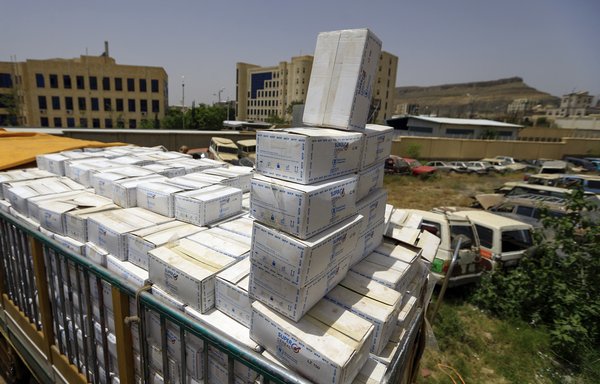 A picture taken on June 23rd shows expired medicine aid packages from the World Food Programme in Sanaa. WFP announced the 'partial suspension' of aid to the city, which is controlled by the Houthis, citing problems with the 'diversion of food' from the neediest for its decision. [Mohammed Huwais/AFP]