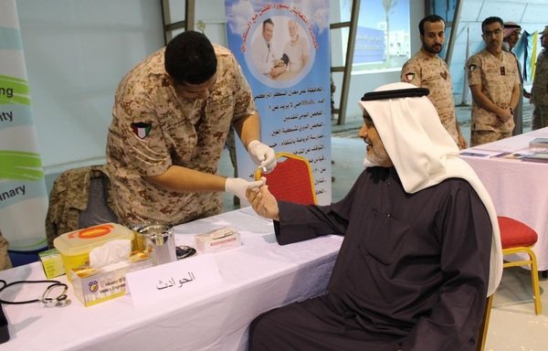 Medics from the Kuwaiti Army's medical team provide services to a civilian. [Photo courtesy of the Kuwaiti Army]