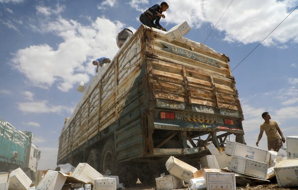 Yemen's Houthis dispose of expired aid packages from the World Food Programme in Sanaa on August 27th. [Mohammed Huwais/AFP]