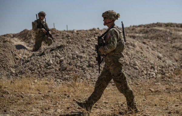 US soldiers take part in a joint patrol with Turkish troops in the Syrian village of al-Hashisha on the outskirts of Tal Abyad town along the border on September 8th. Six Turkish armoured vehicles crossed the border to join US troops in Syria for their first joint patrol under a deal reached between Washington and Ankara. [Delil Souleiman/AFP] 