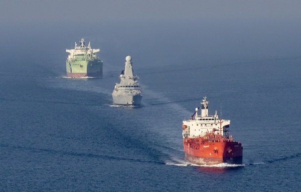 British frigate HMS Duncan escorts two commercial vessels through the Strait of Hormuz. [Photo courtesy of the British Royal Navy]
