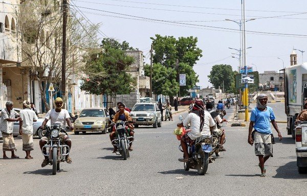 This picture taken on August 30th shows people riding motorcycles along a road in the coastal city of Zinjibar in Abyan province. A motorcycle rigged with explosives detonated on September 12th at a military checkpoint in the Wadi Hadramaut town of Shibam, wounding a soldier and a civilian. [Nabil Hasan/AFP]
