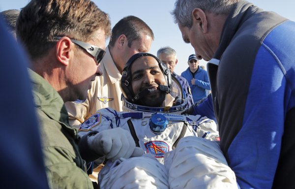 Roscosmos rescue team members and UAE specialists carry Emirati astronaut Hazzaa al-Mansoori shortly after the landing of the Russian Soyuz MS-12 space capsule south-east of the Kazakh town of Dzhezkazgan on October 3rd. [Dmitri Lovetsky/POOL/AFP]