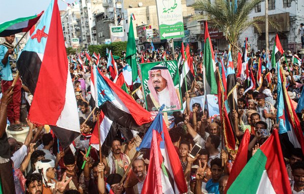 People march with the flags of south Yemen, the UAE, and Saudi Arabia, as a portrait is raised of Saudi King Salman bin Abdulaziz, during a demonstration titled the "million-man march of gratitude for Saudi Arabia and the UAE", in the centre of the second city of Aden on September 5th. [Saleh al-Obeidi/AFP]