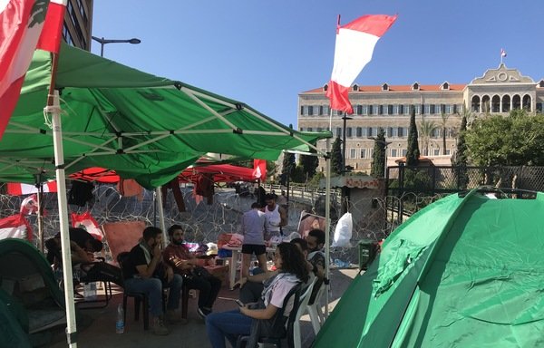 Protesters gather inside their tents in Beirut's Riad al-Solh Square. [Nohad Topalian/Al-Mashareq]