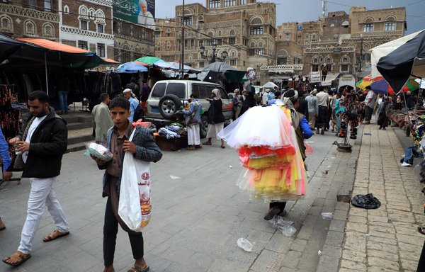 Shoppers throng a market in Sanaa, a city under Houthi control where the Bahai community has faced persecution. [Mohammed Huwais/AFP]