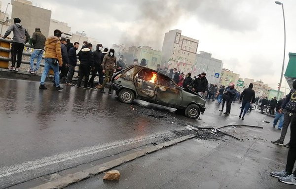 Iranian protestors gather around a burning car during a demonstration in Tehran against an increase in gasoline prices on November 16th. [AFP]