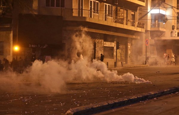 Tear gas fills a street amid clashes between supporters of Hizbullah and Amal and protestors in Beirut on November 25th. [Anwar Amro/AFP]