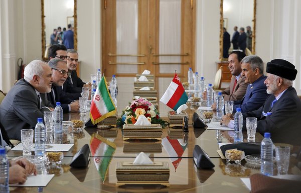 Iran's Foreign Minister Mohammad Javad Zarif (left) meets with Oman's Minister of State for Foreign Affairs Yusuf bin Alawi bin Abdullah (right) in Tehran on December 2nd. [STR/AFP]