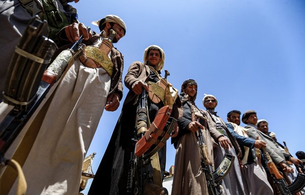 Yemeni men affiliated with the Iran-backed Houthis (Ansarallah) stand with Kalashnikov assault rifles during a tribal meeting in the Houthi-held Sanaa on September 21st. [Mohammed Huwais/AFP]