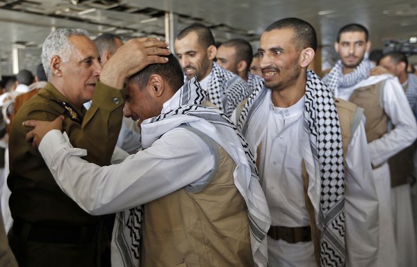سجناء حوثيون أثناء الترحيب بهم عند وصولهم إلى مطار صنعاء عقب إطلاق سراحهم من قبل التحالف العربي يوم 28 تشرين الثاني/نوفمبر. [محمد حويس/وكالة الصحافة الفرنسية]