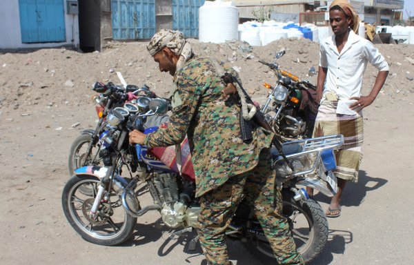 A member of Yemen's security forces checks a motorbike as part of a tight security campaign in second city Aden on December 9th. [Saleh al-Obeidi/AFP]