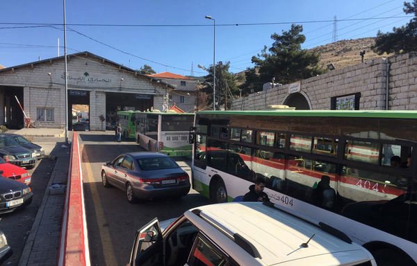 Syrian refugees cross back into their home country from Lebanon in buses and private vehicles. [Photo courtesy of the General Directorate of General Security]
