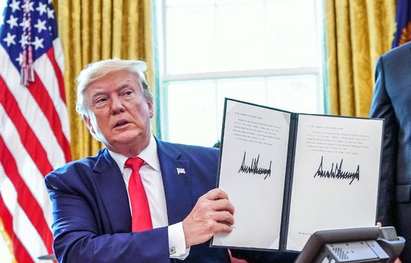 In this file photo taken on June 24th, 2019, US President Donald Trump signs sanctions against Iran's supreme leader at the White House. [Mandel Ngan/AFP]