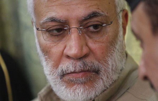 In this file photo taken January 23rd, 2018, Abu Mahdi al-Muhandis, the number two of Iraq's Popular Mobilisation Forces, meets with officials during a visit to Basra. [Haidar Mohammed Ali/AFP]