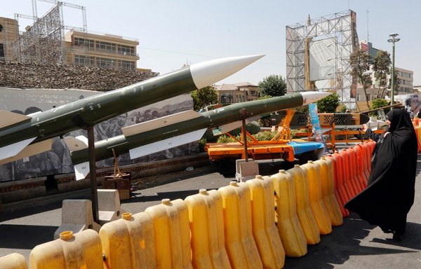 An Iranian woman looks at a Thaer-2 missile during a street exhibition by Iran's army and the IRGC celebrating Defence Week at the Baharestan Square in Tehran on September 26th, 2019. [Stringer/AFP]
