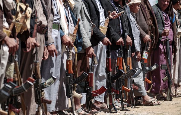 Yemeni men stand with Kalashnikov assault rifles during a tribal meeting in Sanaa on September 21st, as tribesmen donate rations and funds to fighters loyal to the Houthis along the fronts. [Mohammed Huwais/AFP]