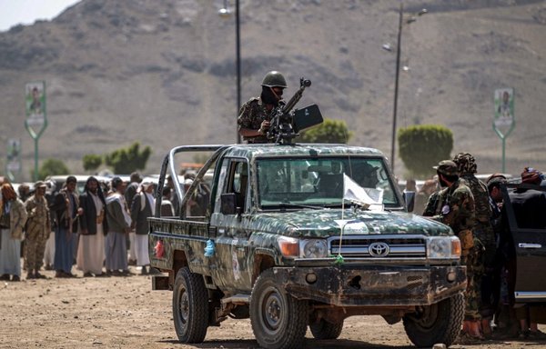 A fighter loyal to Yemen's Houthis mans a machine gun turret in the back of a pickup truck during a tribal meeting in Sanaa on September 21st. [Mohammed Huwais/AFP]
