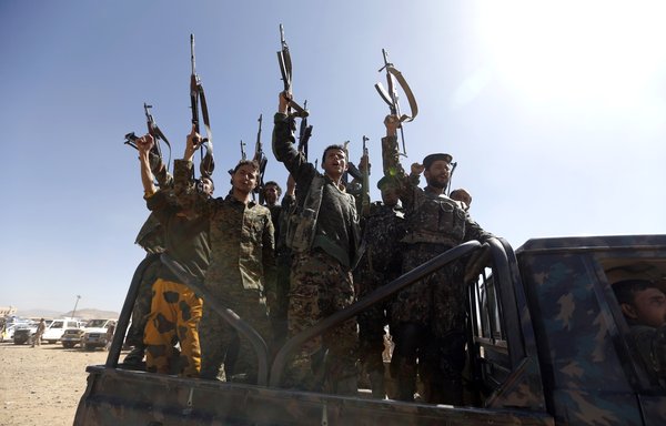 Newly recruited Houthi fighters chant slogans as they ride a military vehicle during a gathering in the capital Sanaa to mobilise more fighters to battlefronts to fight pro-government forces in several Yemeni cities, on January 3rd, 2017. [Mohammed Huwais/AFP]