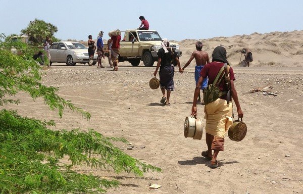 Yemeni pro-government fighters carry explosives and landmines planted by the Houthis on June 8th, 2018, near the city of al-Jah in al-Hodeida province. [Nabil Hassan/AFP]