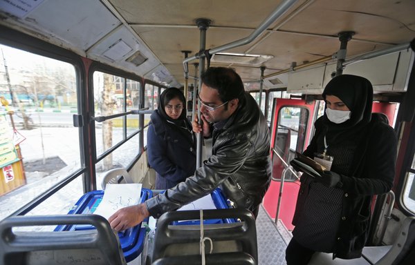 An Iranian man casts his ballot at a mobile polling station in Tehran on February 21st. Electoral authorities in Iran extended voting for several hours in the Islamic Republic's parliamentary election on Friday, state television reported. [Atta Kenare/AFP]