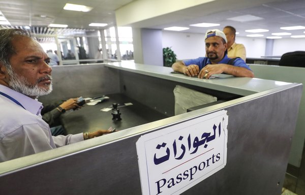 A picture taken August 9th, 2018 shows a passenger waiting to present travel documents to a passport control officer at Aden International Airport. [Karim Sahib/AFP]