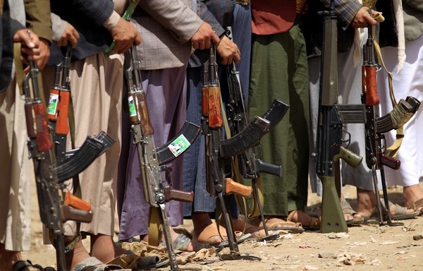 Tribal gunmen loyal to the Houthis protest with their weapons during a gathering in the capital Sanaa on March 16th, 2019. Arab coalition forces have deployed to the Shahn crossing on the border with Oman to limit the smuggling of Iranian weapons to the Houthis. [Mohammed Huwais/AFP]