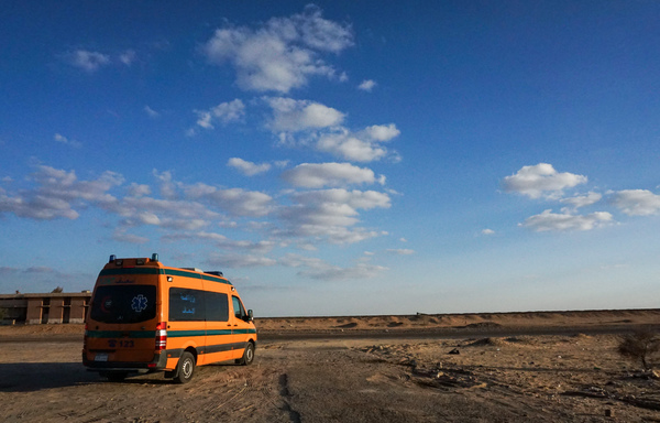 A picture taken on October 21st, 2017 shows an Egyptian Health Ministry ambulance parked in the desert towards the Bahariya oasis in Egypt's Western desert, near the site of an attack that left at least a dozen policemen killed in an ambush by Islamist fighters, including top militant Hesham Ashmawi who was executed by hanging on March 4th, 2020. [Mohamed el-Shahed/AFP]
