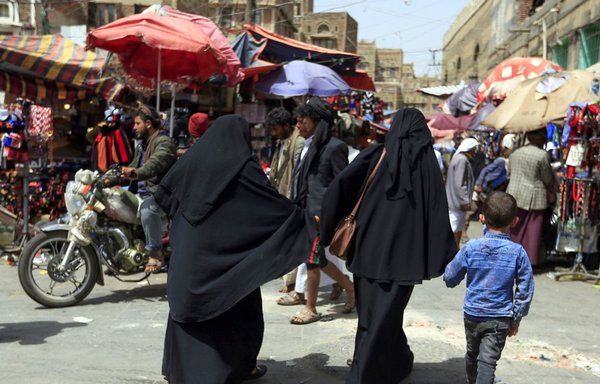 Yemeni women walk in the old city market of Sanaa, on March 2nd. In recent months, a series of incidents in the Houthi-held north illustrates the militia's determination to impose their own moral order on Yemenis. [Mohammed Huwais/AFP]