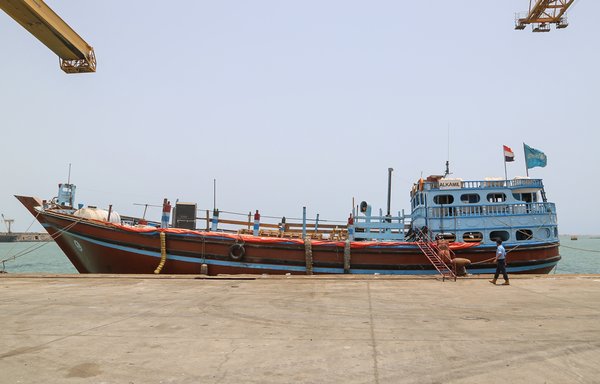 A member of the Yemeni coast guards walks past a ship at Salif port in al-Hodeidah province on May 13th, 2019. [AFP]