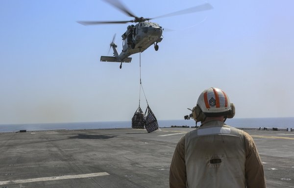 An MH-60S Sea Hawk delivers cargo during a replenishment-at-sea aboard the amphibious assault ship USS Bataan March 4th. Bataan, with embarked 26th MEU, is deployed to the US 5th Fleet area of operations in support of naval operations in the region. [US Marine Corps]