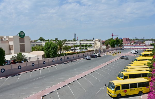A picture taken on March 15th shows school buses parked outside a closed school in Dubai. [Giuseppe Cacace/AFP]