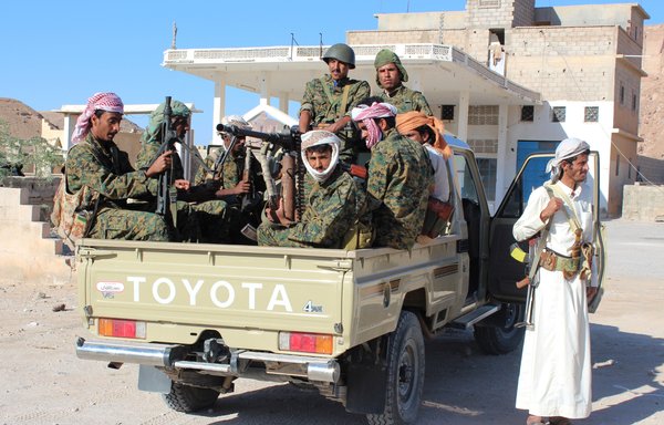 Pro-government forces sit in the back of a truck as they patrol an area of Shabwa province on December 21st, 2015. [Saleh al-Obeidi/AFP]