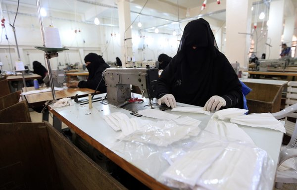 Yemeni women make face masks at a textile factory in Sanaa on March 16th. [Mohammed Huwais/AFP] 
