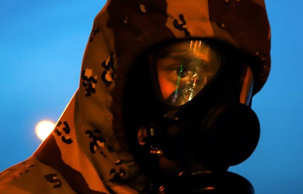 An Iranian health worker at a scanning station in Tehran in early March, taking temperatures of commuters. [ISNA]