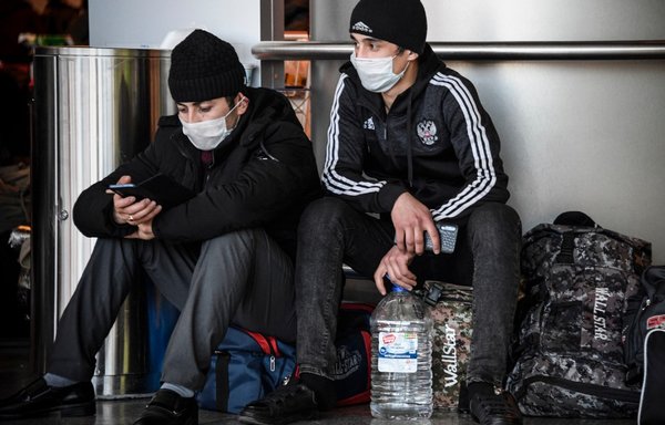 Citizens of Central Asian countries, who are stuck in Moscow after flights were stopped over the coronavirus pandemic, wait for flights to return home at Moscow's Vnukovo airport on March 24th. [Alexander Nemenov/AFP]