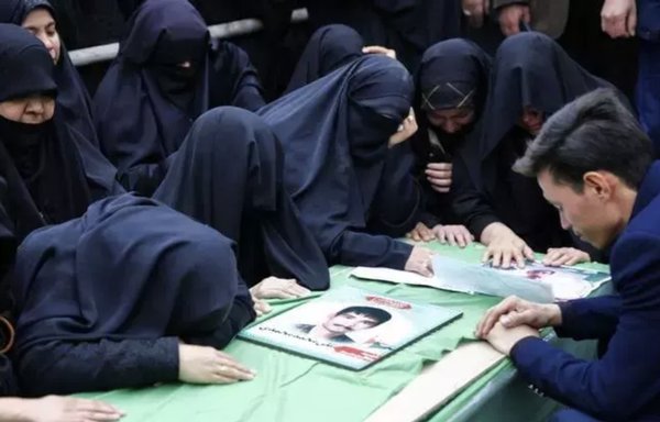 Mourners weep over the coffin of a Fatemiyoun Brigade fighter killed in Syria during a funeral in Mashhad, Iran, on February 20th. [File]