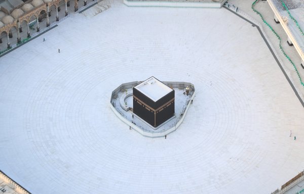 An aerial view shows an empty white-tiled area surrounding the Kaaba in Mecca's Grand Mosque on March 6th, where strict measures have been taken to protect against novel coronavirus (COVID-19). [Bandar al-Dandani/AFP]
