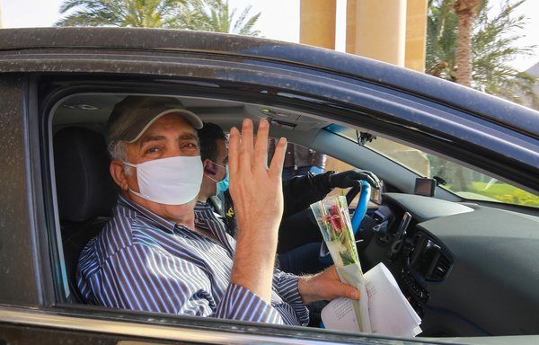 A mask-clad man gestures as he leaves a Dead Sea resort where he has been quarantined for 14 days, approximately 60 kilometres south of Amman on March 30th. Jordanian authorities started to take home about 5,000 people quarantined in hotels to guard against the spread of coronavirus since their return to the country two weeks ago. [Khalil Mazraawi/AFP]