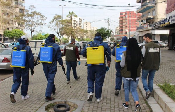 Utopia Task Force volunteers spray the streets of Tripoli with disinfectant to protect against novel coronavirus. [Utopia Task Force]