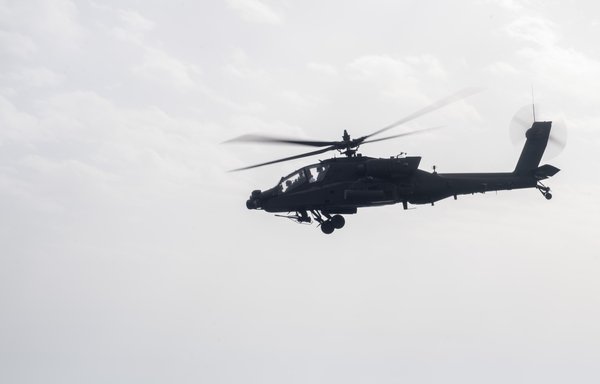 An Apache helicopter flies over Gulf waters during recent US military exercises. [US Navy]