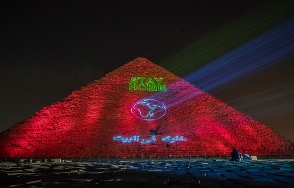 A public health message to 'stay home' is projected onto the pyramid of Kheops at Giza outside the Egyptian capital of Cairo on March 30th, amid the spread of novel coronavirus. [Khaled Desouki/AFP]