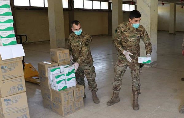 Members of the Lebanese forces hand out personal protective equipment donated by the US military. [Photo courtesy of Lebanese Army Command, Directorate of Guidance]