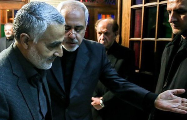 Former IRGC Quds Force commander Qassem Soleimani and Foreign Minister Mohammad Javad Zarif attend Zarif's mother's funeral in 2013. [Fars News Agency]
