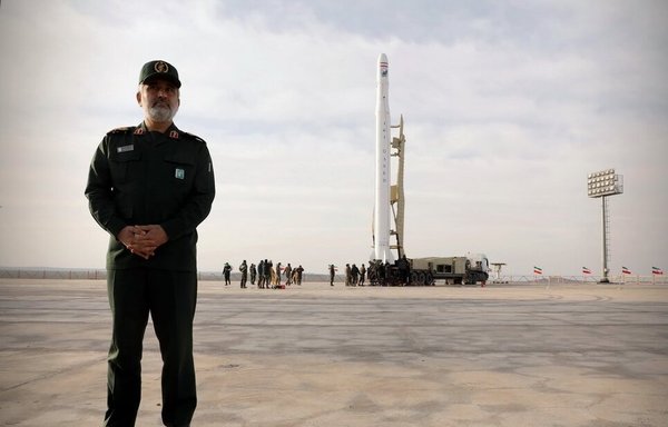 IRGC Aerospace Force commander Brig. Gen. Amir Ali Hajizadeh stands near the Qassed rocket shortly before it lifted off into space. [Photo via Mehr News]