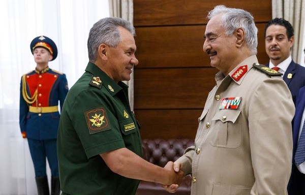 Russian Defence Minister Sergei Shoigu (left) shakes hands with Marshal Khalifa Haftar in Moscow during talks in 2017. [Russian Ministry of Defence]