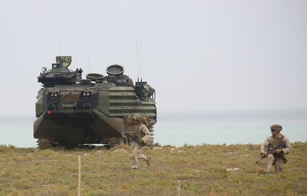 Two marines from the Bataan Amphibious Ready Group land on the beach of the Saudi island of Karan. [Photo courtesy of US Central Command]