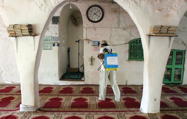 A Yemeni worker disinfects inside a mosque in the northern Hajjah province on May 7th, as part of measures to curb the spread of coronavirus. [Essa Ahmed/AFP]