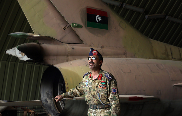 Group Captain Muhammad Qanunu, military spokesperson of the Libyan Government of National Accord (GNA) forces, stands by a partially disassembled MiG-23 aircraft, after seizing al-Watiya air base, south-west of Tripoli, on May 18th, from forces loyal to Kremlin-backed strongman Khalifa Haftar. [Mahmud Turkia/AFP]